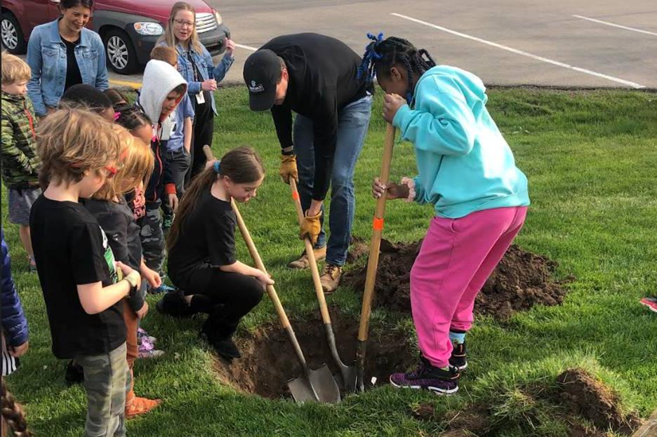 Grand Rapids Christian Elementary school students planting a tree